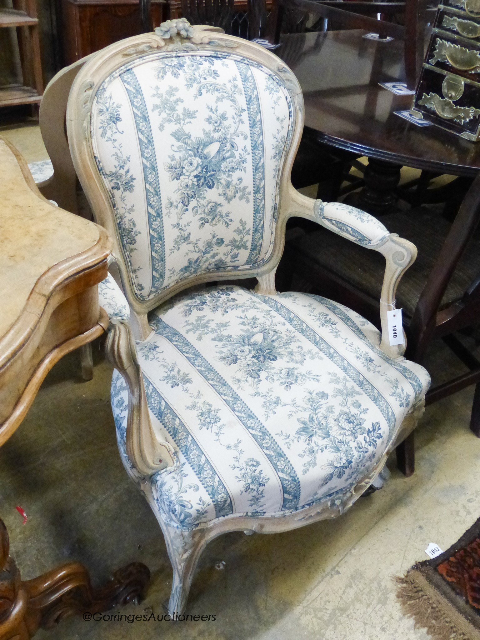 A pair of Louis XVI style upholstered elbow chairs.